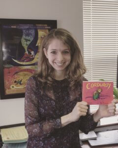 girl with favorite children's book Corduroy