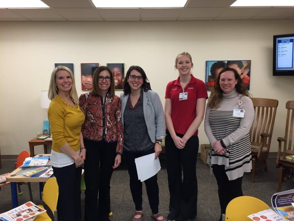 Madison Public Library Youth Services Librarian Holly Storck-Post (middle) with UW Health 20 South Park Street Staff and reading volunteer